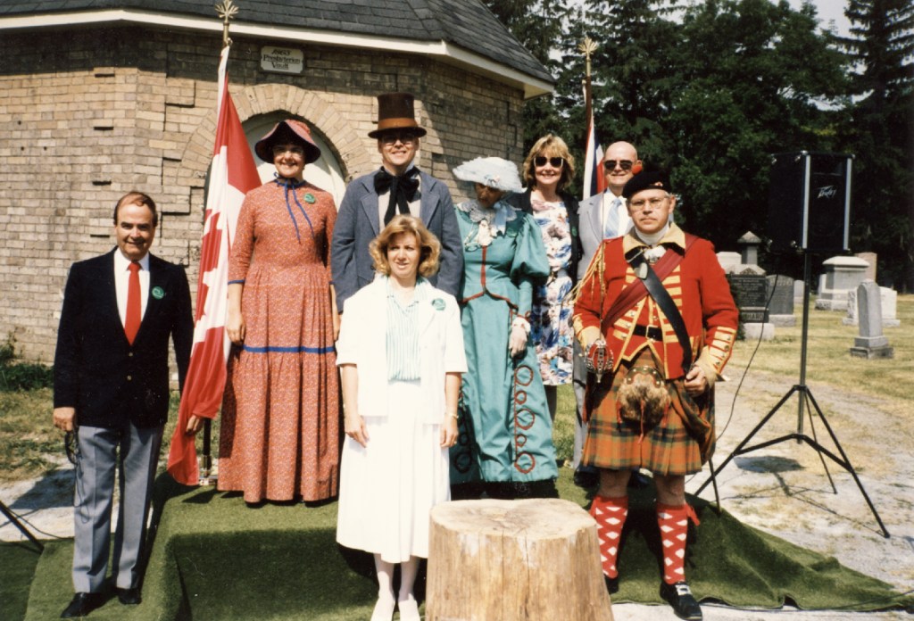 Colour image of Cheryl Butler and other Richmond Hill Historical Society members at the Founders Day celebration at the Richmond Hill Presbyterian Church Cemetery in June 1988.